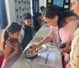 Class 1 students presenting Indian state-wise famous food exhibition