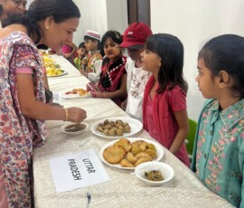 Class 1 students presenting Indian state-wise famous food exhibition