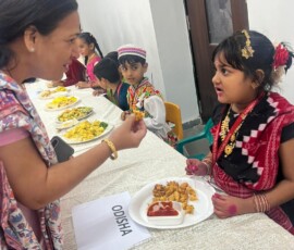 Class 1 students presenting Indian state-wise famous food exhibition