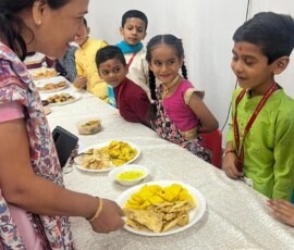 Class 1 students presenting Indian state-wise famous food exhibition